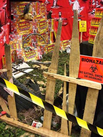 A close-up of our stand, complete with fag packets, pornography and dollar bills screwed up and thrown on the ground. People loved it.