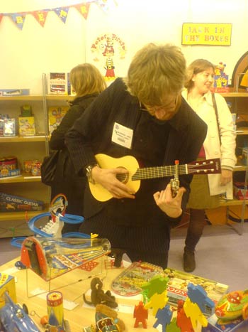 Always time for a bit of a jam session. Slide miniature guitar with a toy gun ...