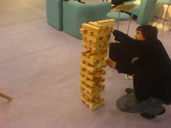 Andy S 'not really cheating' by using a frowned-upon 2 hand technique at giant Jenga