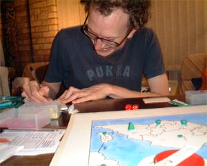 Andy T writing a secret message and finding it hilarious.