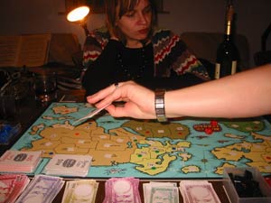 Fiona tries to look unperturbed by Jenn's rapid accumulation of cards.